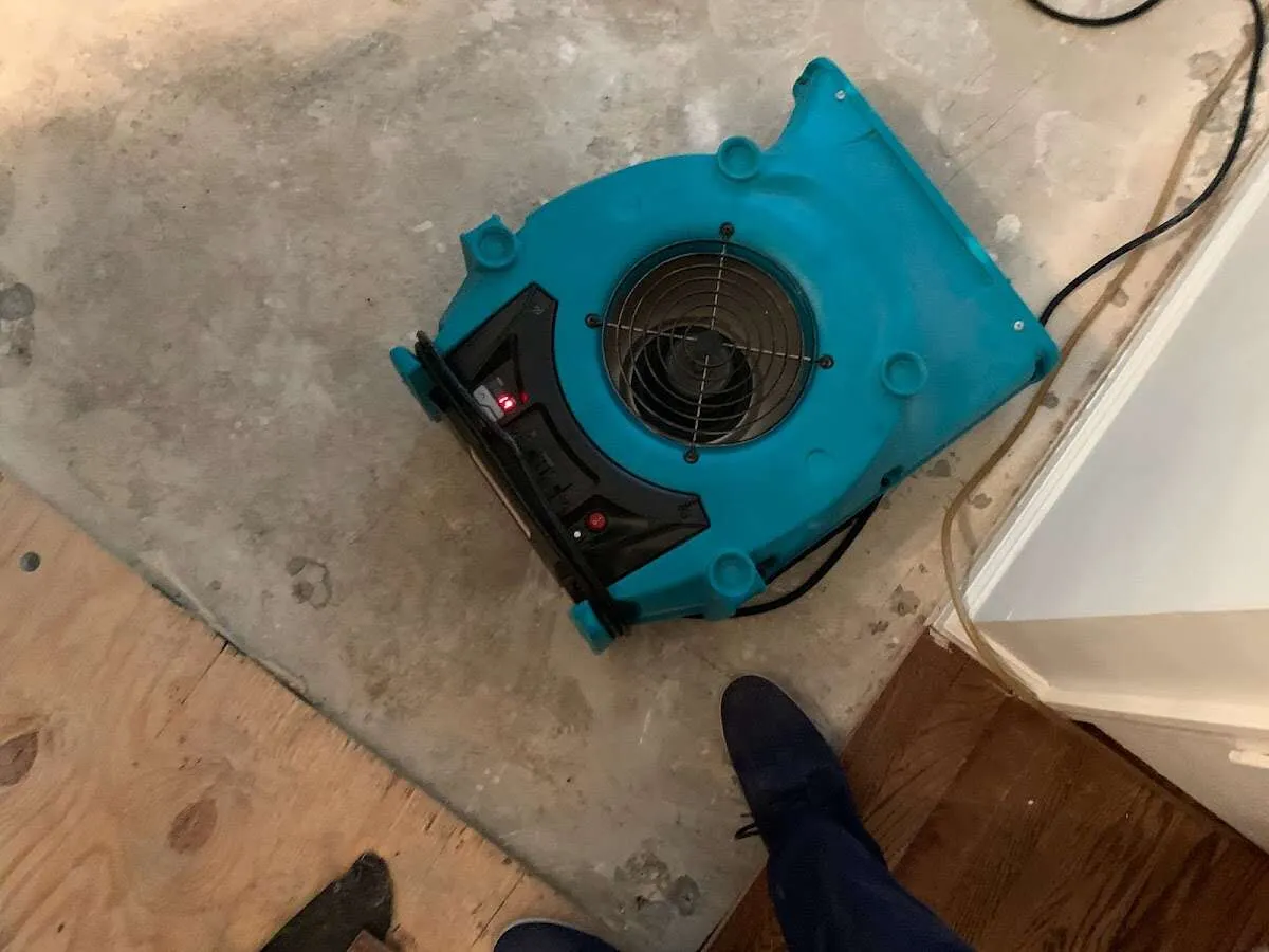 Air mover drying subfloor during Commercial Water Damage Restoration in Jurupa Valley